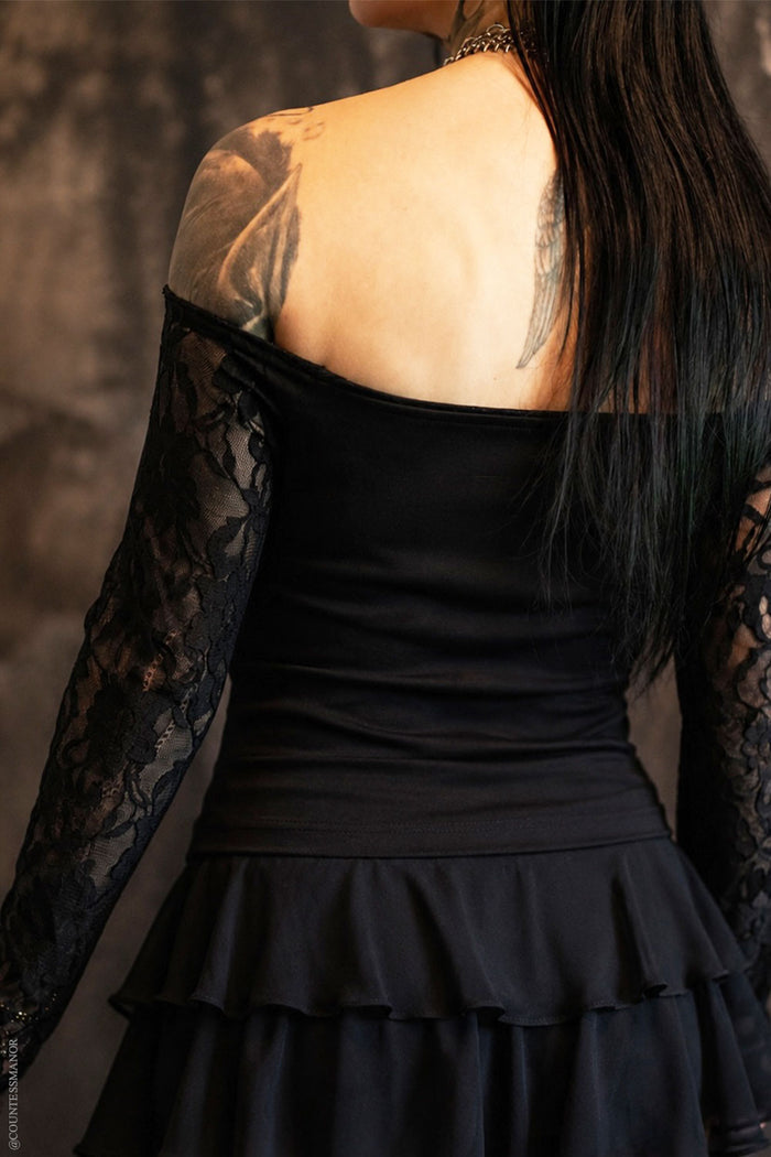 Model wearing off shoulder black top with lace sleeves from VampireFreaks