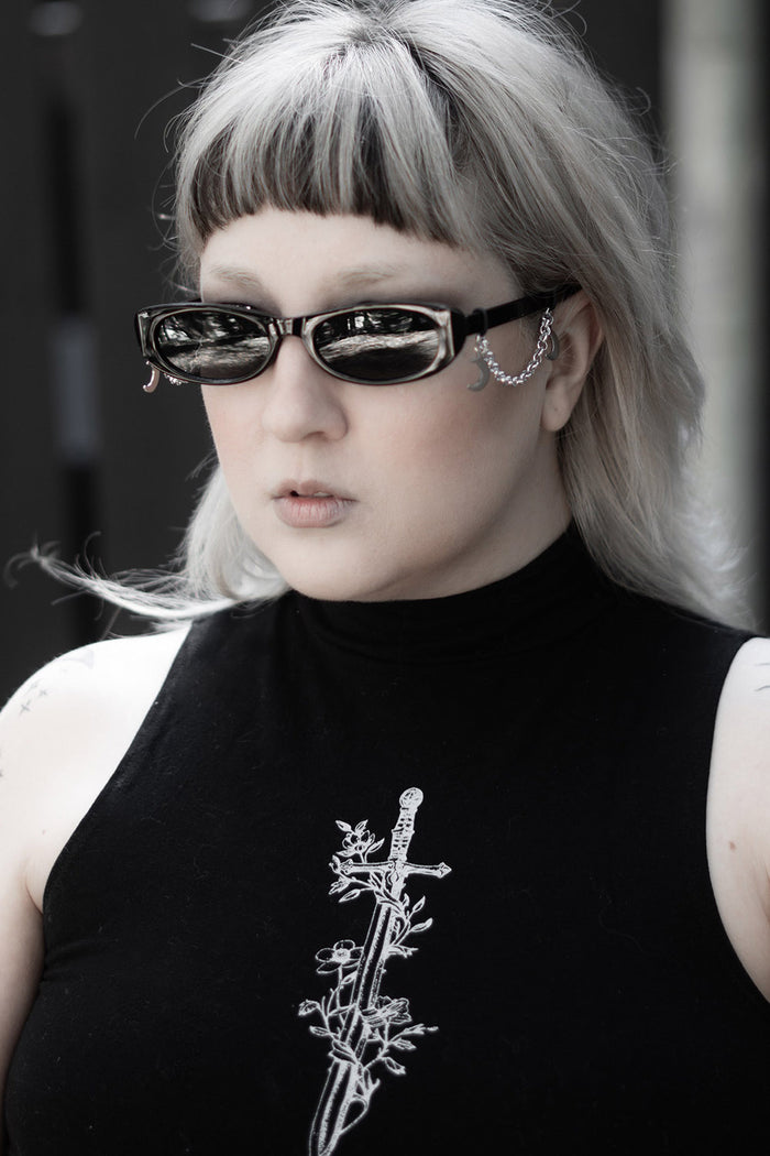 thin oval black sunglasses with crescent moon charms  by the pretty cult
