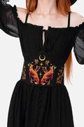 Black corset with colorful embroidery on a plain background