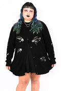Black button up cardigan with an embroidered fish skeleton pattern