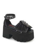 Black platform sandal with decorative straps on a white background
