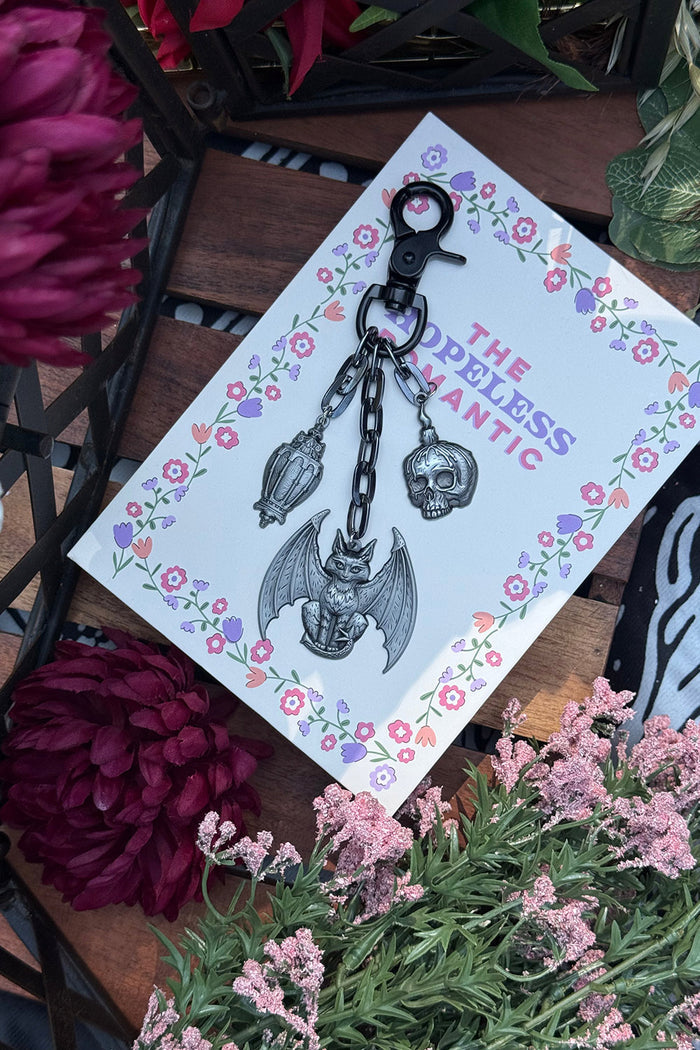 batwing act, lantern, and skull charm keychain