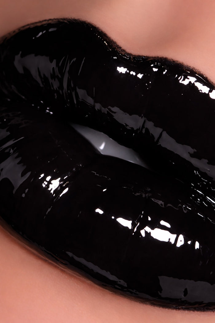 Close-up of glossy black lipgloss