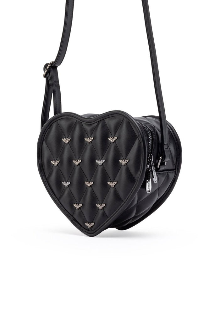 A black heart-shaped quilted crossbody bag with small metallic bee embellishments, a front zipper pocket, and a thin shoulder strap, shown on a plain white background.