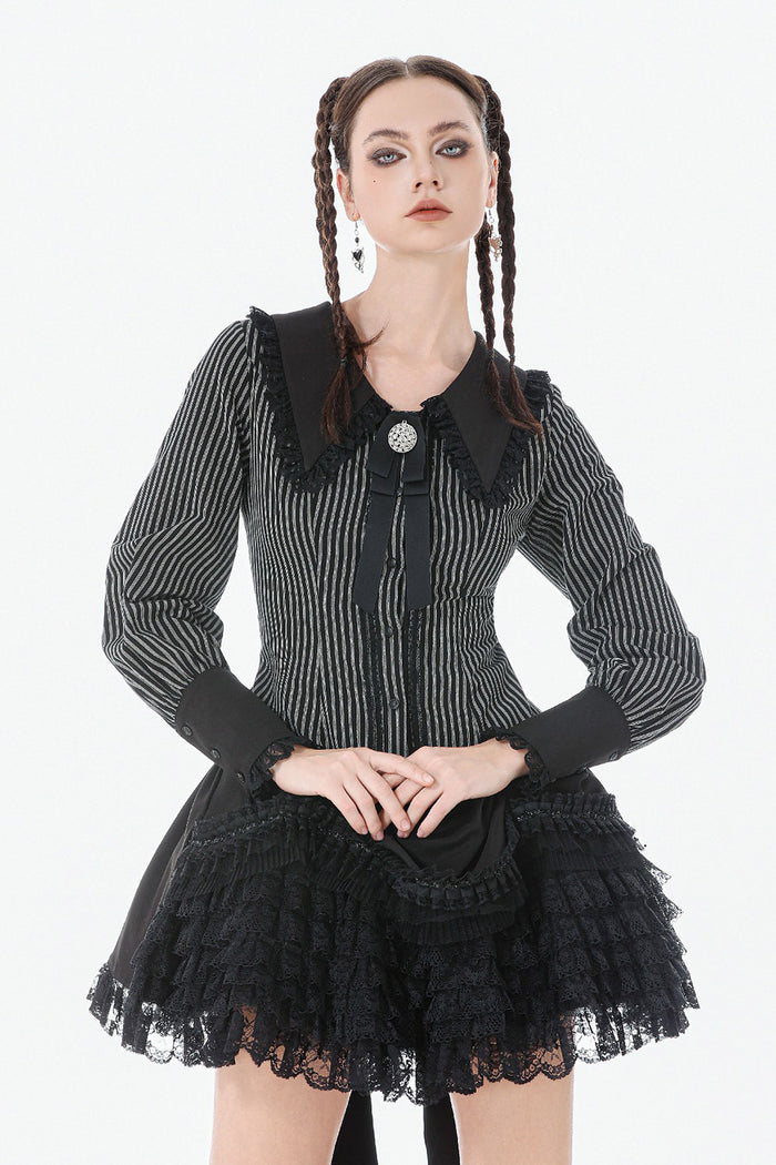 gothic woman wearing a long sleeves womens striped blouse with puffed sleeves and black cuffs