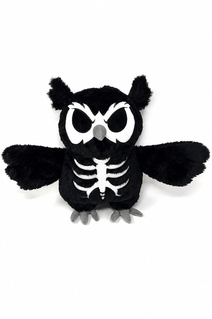 A black plush owl toy with a white skeleton print on its chest, large white eyes, and gray beak and feet, shown against a plain white background.