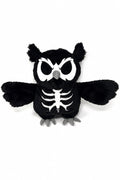A black plush owl toy with a white skeleton print on its chest, large white eyes, and gray beak and feet, shown against a plain white background.
