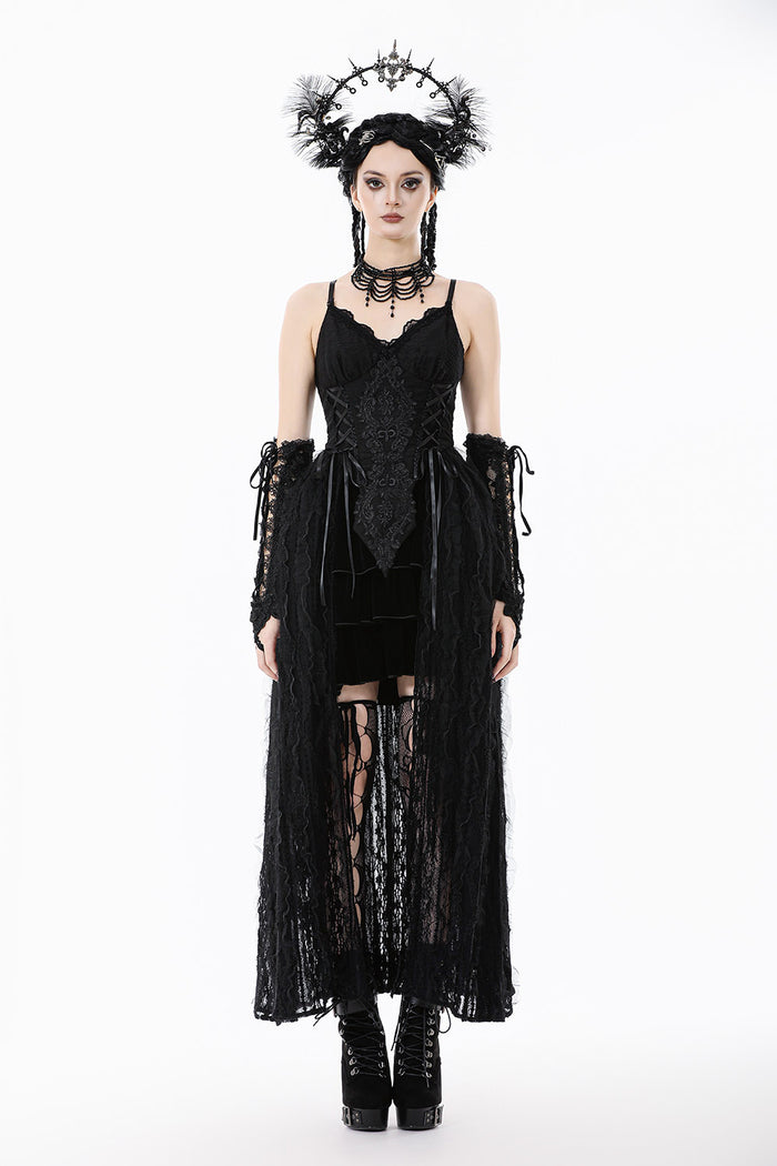 Woman wearing a black gothic outfit with lace details on a white background