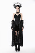 Woman wearing a black gothic outfit with lace details on a white background