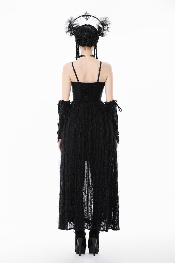 Black dress with sheer panels and intricate detailing on a white background