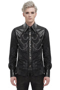 Man wearing a black, ornate shirt with leather accents on a white background