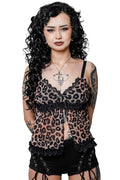 Woman wearing a leopard print top with black lace details on a white background