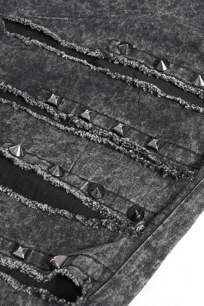 Close-up of a textured goth pant with metallic studs and rivets.
