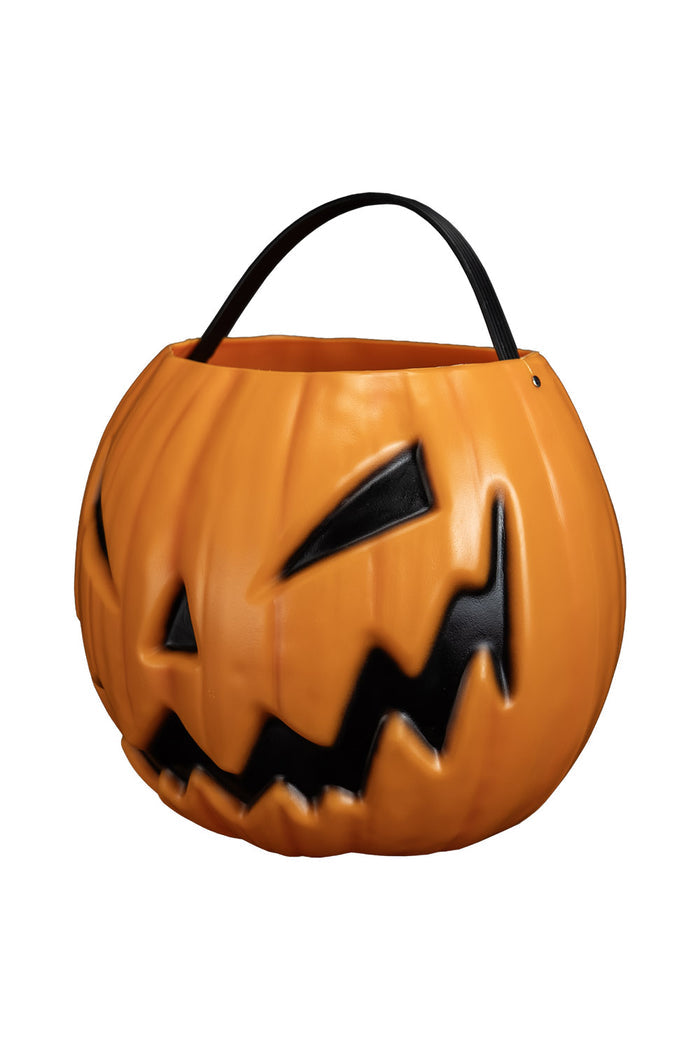 Pumpkin-shaped Halloween candy bucket with a carved face on a white background