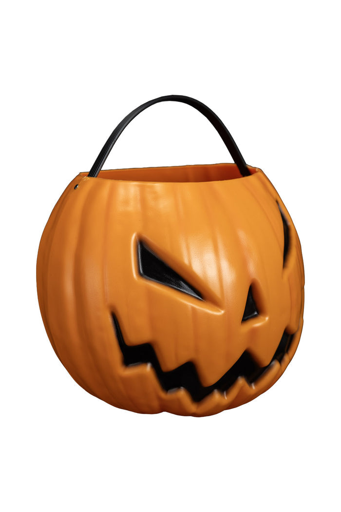 Pumpkin-shaped Halloween candy bucket with a carved face on a white background