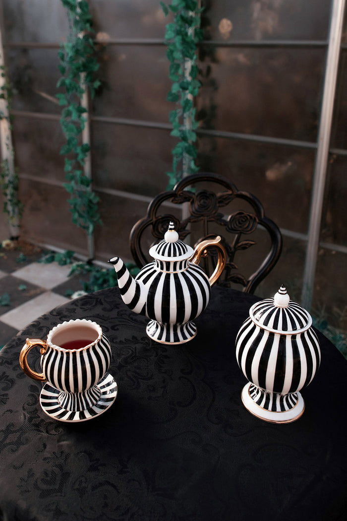 steampunk tea pot, tea cup, and sugar jar