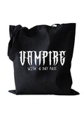 Black tote bag with 'Vampire with a Day Pass' text on a white background