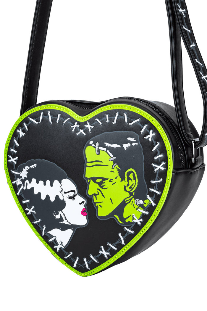 Heart-shaped bag with a design of a frankenstein and his bride facing each other